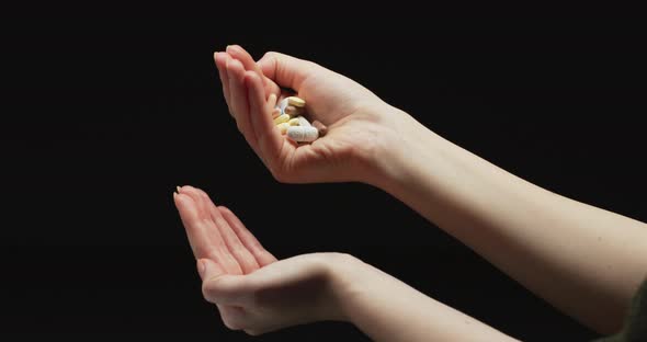 Pouring pills from one hand to another alt