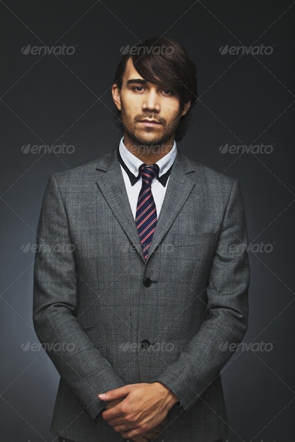 Handsome young businessman looking at camera