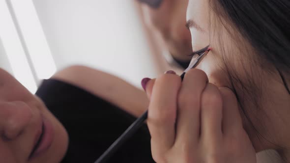 Young Asian Model's Face During the Make-up Process. alt