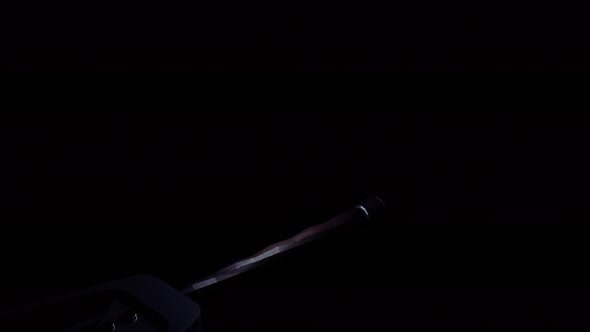 A medieval sword of silver color flying against black backdrop alt