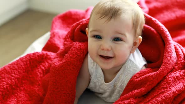 Cute baby girl on bed in bedroom alt