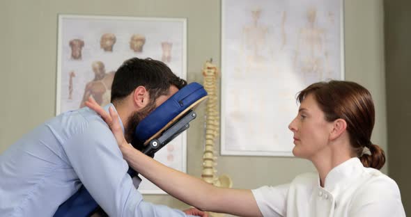 Female physiotherapist giving arm massage to a patient alt