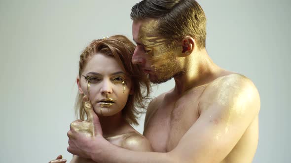 Romantic Passion Dating and Love. Beautiful Couple with Golden Art Makeup Touch Each Other. Fashion alt