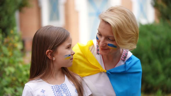 Pretty Ukrainian Daughter and Beautiful Mother Looking at Each Other Smiling Turning to Camera in alt