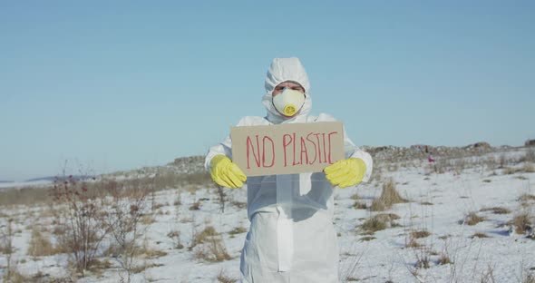 Wore in White Full Cover Suit Man Shows Sign Protest Against Plastic Pollution alt