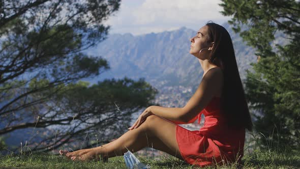 Pretty Woman Remove Medical Face Mask and Breathing Air in Mountains Outdoors alt