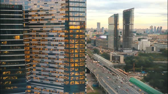 A View on the Skyscrapers in the Busy Street - the Sun Getting Down and Lights Are Lighting Up alt
