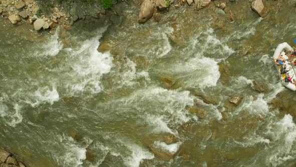 Aerial View of People Rafting on Mountain River alt
