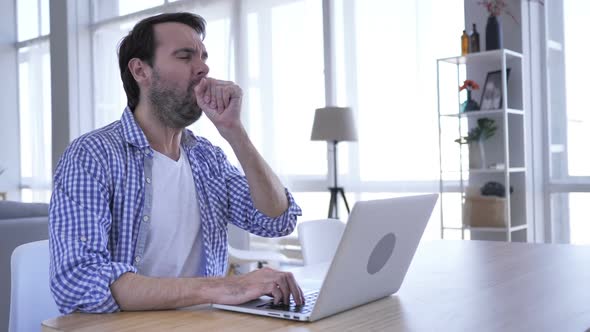 Casual Beard Man Coughing While Working on Laptop Throat Infection alt