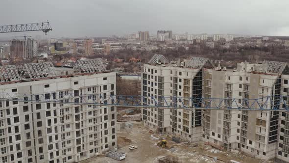 Aerial Shot of Construction Cranes and the Construction of a Number of New Modern White Buildings alt