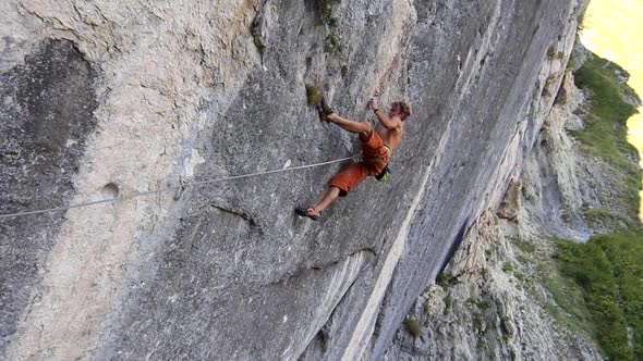 A man rock climbing up a mountain. alt