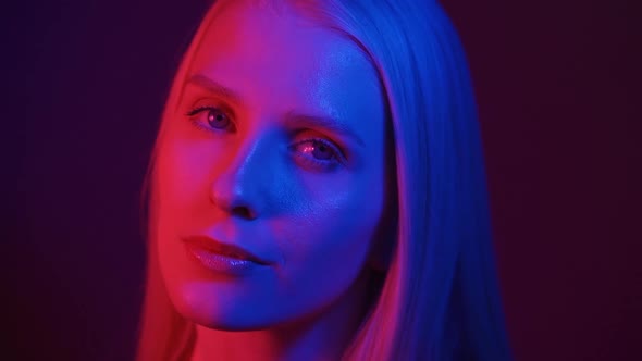 Portrait of a Young Woman Model in Neon Light