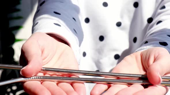 Slow Motion Woman Holding Reusable Metal Straw alt