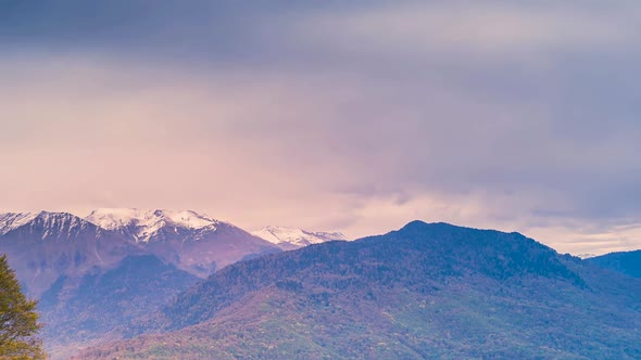 Time lapse of an autumn mountain scene panningalong a cloudscape forming over the ridgline of the Ro alt