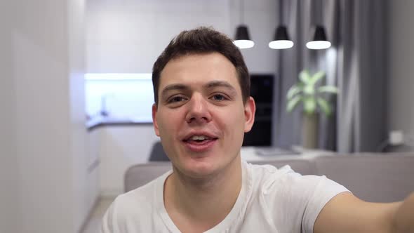 Smiling Young Blogger Making Selfie or Video Call While Sitting at Home on Sofa alt