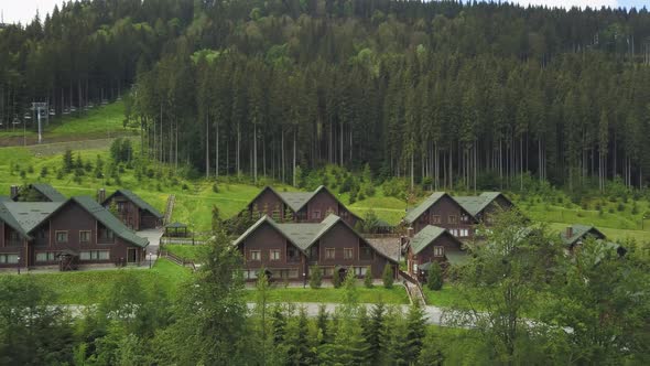 Wooden cottages in the ski resort Bukovel, Ukraine. Summer holidays in the Carpathian mountains