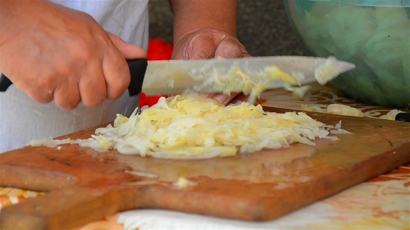 Woman Cutting Cabbage With Knife 01