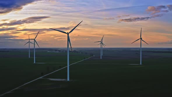 Aerial view of stunning wind turbines at dusk, Poland alt