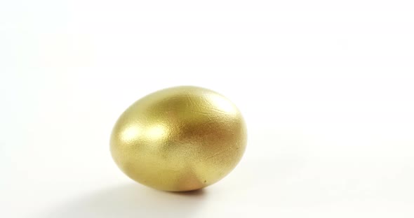 Golden Easter egg on white background alt