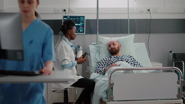 Physician with Dark Skin Explaining Pills Treatment Against Pain alt