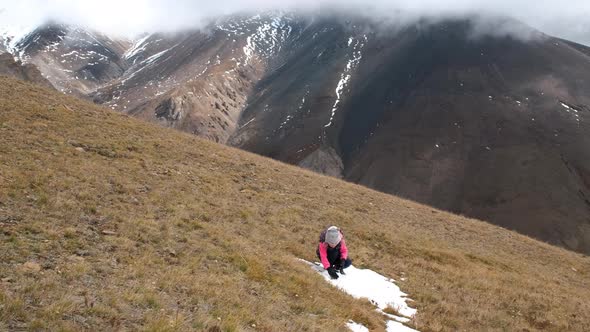 Little Girl Playing Snowballs in Mountains alt