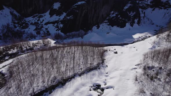 aerial footage of glacial landscape in Swiss Alps, flying backwards alt