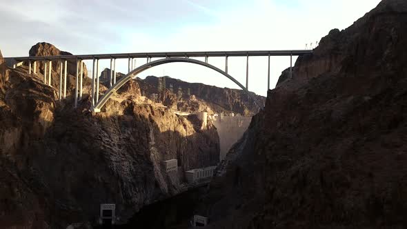 4K Aerial View of Hoover Dam and Colorado River Bypass Bridge from down in the Colorado River gorge alt