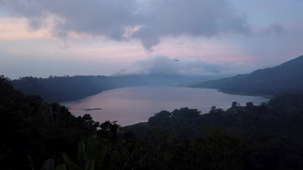 Twin lakes view point day to night time lapse. Tamblingan Lake, Buyan Lake. Running clouds pink sky alt