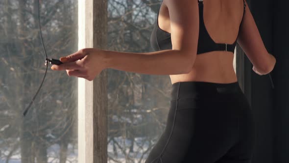 Young Woman Is Jumping with Rope in Sports Studio alt