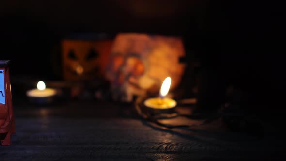 The concept of the Halloween festival with the orange pumpkin, candle light, and the bone skull