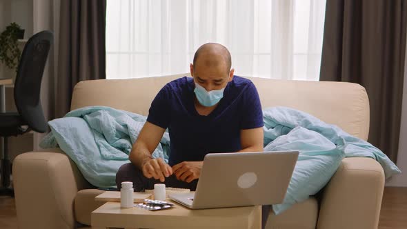 Man Wearing Mask on a Video Call with His Doctor alt