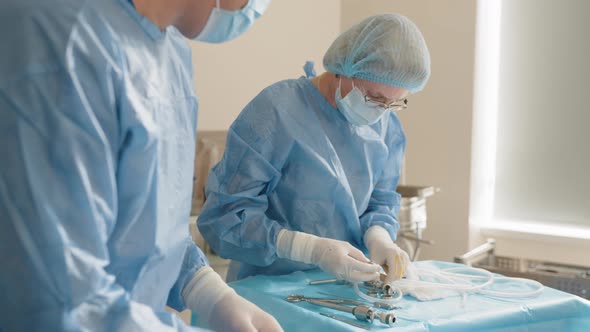 Close Up of Hands Group of Surgeons at Work alt
