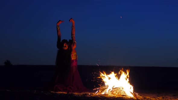 Late Night a Girl in the Sand Dancing Belly Dancing Near a Bright Campfire alt
