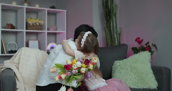 Little Daughter Congratulates Her Mother on Mother's Day alt