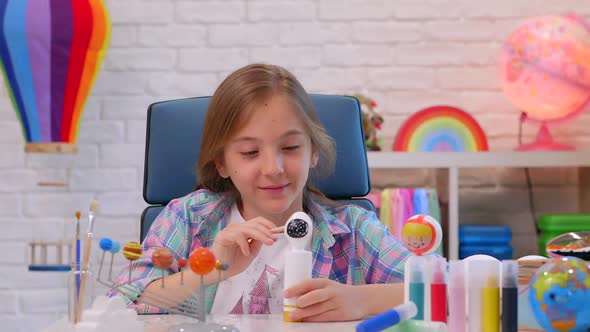 Homework Paintbrush in Hand of Wood Model Astronaut in House Room