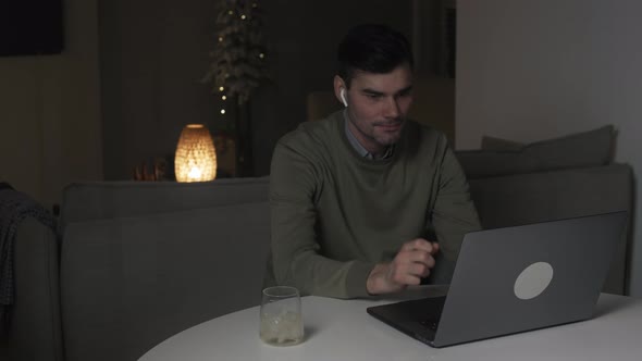 Confident man working on laptop computer