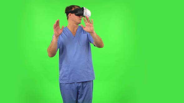 Medical Man with Virtual Reality Headset or 3d Glasses. Green Screen alt