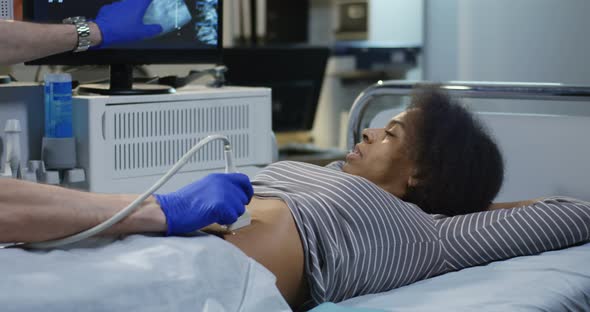 Doctor Examining Woman with Ultrasound alt