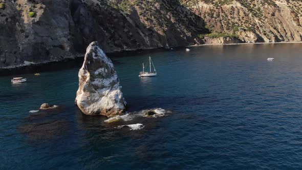 Aerial View of the Rocky Coast of the Bay with Detached Rocks and Boats with Tourists Swimming alt