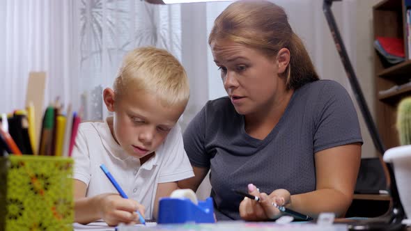 An Angry Mother Scolds Her Son for a Mistake in Homework alt