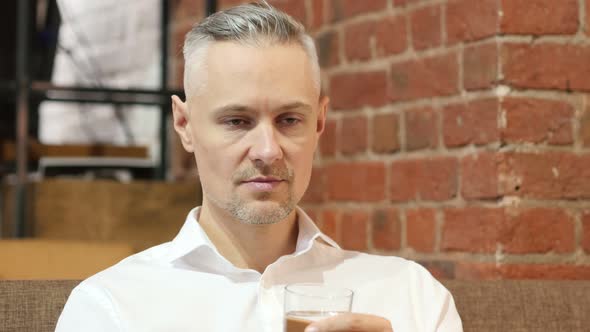 Portrait of Middle Age Man Drinking Water alt