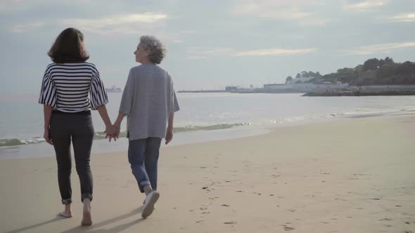 Happy Mature Women Walking To Sea alt
