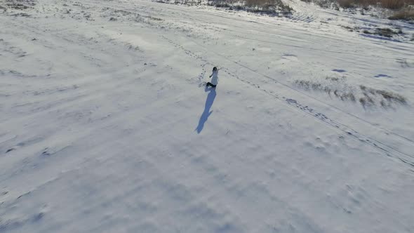 Aerial View Girl in Field in Winter