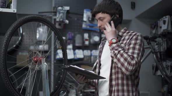 Male Small Business Owner Selling and Repairing Bike alt