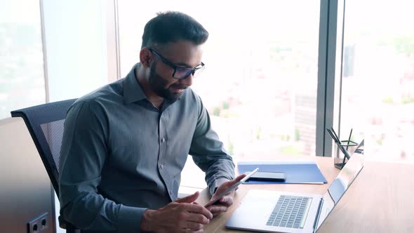 Young Indian Manager Having Working Video Call Using Pc and Tablet in Office alt
