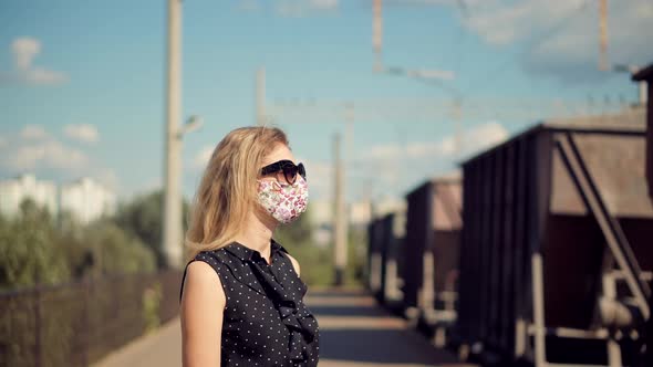Female Waiting Train Wearing Protective Mask COVID19 Virus. Health And Safety Concept. alt