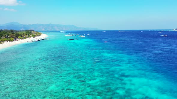 Wide angle above travel shot of a paradise sunny white sand beach and aqua turquoise water backgroun alt