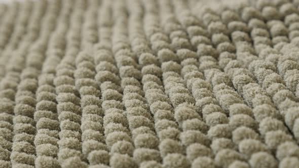 Gray bathroom rug texture close-up 4K panning footage