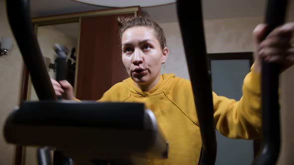 Hard home workout of a young woman who is sweating alt