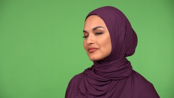 A Young Beautiful Muslim Woman Smiles at the Camera  Closeup  Green Screen Background